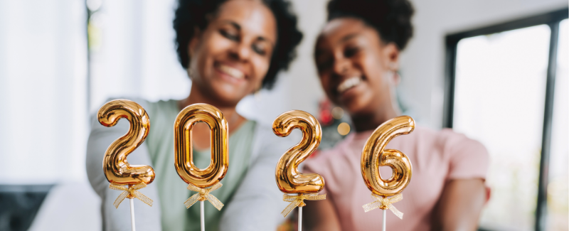 Two women holding 2026 candles
