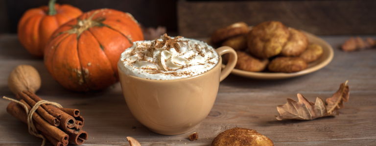 Pumpkin spice latte with pumpkins and leaves
